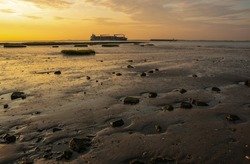 Seascape, during ebb. Low tide. Sunset in Zeeland, Netherlands 