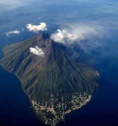 Aerial view of an active volcano. Ginostra island and Stromboli volcano smoking - Eolie islands, Sicily, Italy - November 2014