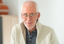 Senior man with grey hairs wearing eyeglasses 
