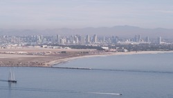 San Diego city skyline, cityscape of downtown with highrise skyscrapers, California coast, USA. View of Coronado island from above, Point Loma vista viewpoint. Frigate sail-powered ship, windjammer.