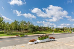 Outdoor blue sky and white clouds under the wide road and park city，dalian