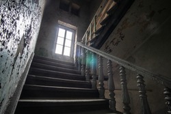 Way up to the window in the staircase in an old abandoned 19th century house