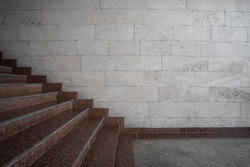 Granite stairs on the background of a wall of shell rock side view