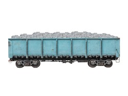 Blue metallic goods wagon or freight wagon with gray bricks isolated on white. 