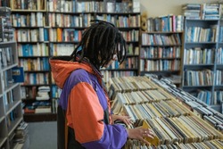 Woman seen searching through vinyl records