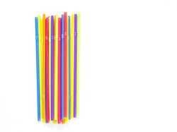 a row of colorful plastic flexible straws isolated on white