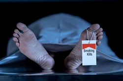 Anti smoking advertising design image. Dead body at morgue with toe tag with text Smoking kills written on it. Social awareness campaign Say NO to Tobacco and health effects of cigarette smoking.
