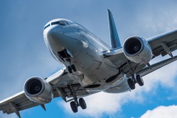Sharp, telephoto close-up image of aircraft landing at airport, BC, Canada