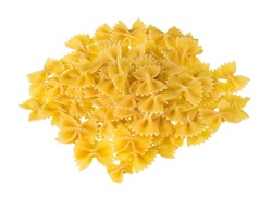 Heap of dry eggless farfalle pasta isolated on a white background. Closeup of spilled yellow bow-tie pastas pile from wheat semolina. Butterfly shaped meal with saccharides, starch and gluten content.