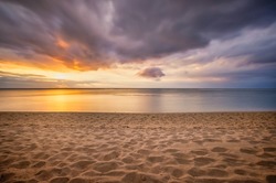 Impressive sunset at the beach of Le Morne, Mauritius in Africa as long exposure photo.