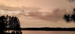 Monotone Sunset over Cloudy Lake Horizon