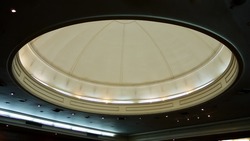 An interior dome ceiling with lightings in a conference room