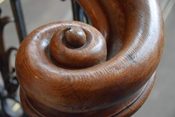 End of an antique staircase handrail in spiral form