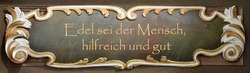 A quote from Goethe in a baroque frame: Noble be the human being, helpful and good. 