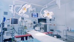 Establishing Shot of Technologically Advanced Operating Room with No People, Ready for Surgery. Real Modern Operating TheaterWith Working equipment,  Lights and Computers Ready for Surgeons.