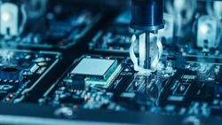 Close-up Macro Shot of Electronic Factory Machine at Work: Printed Circuit Board Being Assembled with Automated Robotic Arm, Place Technology Mounts Microchips to the Motherboard