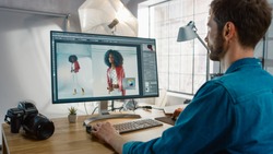 Professional Photographer Sitting at His Desk Uses Desktop Computer in a Photo Studio Retouches. After Photoshoot He Retouches Photographs of Beautiful Black Female Model in an Image Editing Software