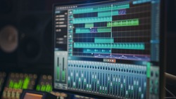 Modern Music Recording Studio Equipment: Computer Screen Showing User Interface of DAW Digital Audio Workstation Software with Track Song Playing. Sound and Music Recording and Editing Application