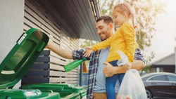 Father Holding a Young Girl and Throw Away an Empty Bottle and Food Waste into the Trash. They Use Correct Garbage Bins Because This Family is Sorting Waste and Helping the Environment.