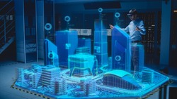 Industry 4.0: Modern Professional Architect Wearing Virtual Reality Headset Uses Gestures to Design, Manipulate Buildings for 3D City. Mixed Augmented Reality Software. VFX Graphics Effect