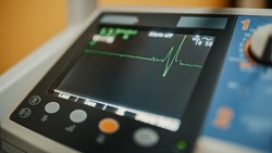 Vital Signs Monitor Showing Heart Rate and Other Medical Parameters on a Digital Display. Patient's Vitals on a Screen in Healthcare Hospital. ECG Graph on Intensive Care Unit.