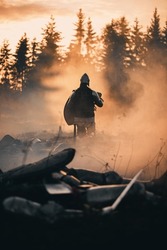 Medieval Knight Walking on Battlefield amidst Dead Enemies. Surviving Crusader, Soldier, Warrior after Battle. Smoke and Destruction of War, Invasion, Crusade. Dramatic, Cinematic Historic Reenactment