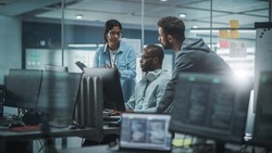 Diverse Group of Professionals Meeting in Modern Office: IT Programmers Use Computer, Talk Strategy, Discuss Planning. Specialists Create Innovative Software. Engineers Develop Inspirational App