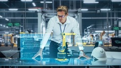 Industry 4.0 High-Tech Factory: Robotics Engineer Working on Robot Arm Design, Using Augmented Reality Hologram to Analyze Conceptual 3D Model. Futuristic Engineering with Digital Technology