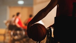 Wheelchair Basketball Game: Player Wearing Red Shirt Holding Ball, Ready to Join the Game. Determination, Motivation of People with Disability Excelling at the Sport. Close-up Shot.