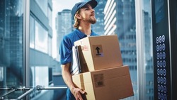 Young Delivery Person Riding Glass Elevator in Modern Office Building. Mail Courier Holding Cardboard Parcel Boxes. Handsome Mailman Delivering Fragile Packages in Business Center Lift.