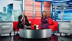 Talk Show TV Program and News Discussion: Two Charismatic Presenters Talk, Have Fun. Cable Channel Hosts Have Friendly Conversation. Morning, Breakfast Television Entertainment in Studio Concept