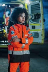 Vertical Photo: Portrait of Beautiful, Multiethnic, Female Paramedic Specialist on Late Night Shift. Heroic Empowering Woman Seriously Looking Away and posing for Camera, Reporting for Duty