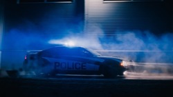 Highway Traffic Patrol Car In Pursuit of Criminal Vehicle. Police Officers in Squad Car Chase Suspect on Road During a Misty Night. Cinematic Industrial Area. Action Scene