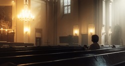 Christian Woman Sits Piously in Church, Praying, Seeks Guidance and Solace from Religious Faith and Spiritual Belief in God. Cinematic Camera Moving from Ceiling Painting of Jesus Christ to a Woman