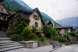 Traditional rustic stone house with lots of flowers spotted in the beautiful village Sonogno, Ticino, Switzerland