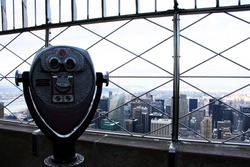 Binoculars viewing over Manhattan from Empire State Building, in New York
