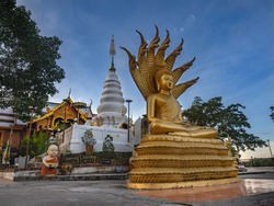 Buddha image with a naga and a pagoda of Buddha's relics at Wat Phra That Doi Leng in Phrae Province, Northern of Thailand. Buddha with Naga Statue called 