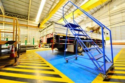 Blue ladder with wheels for entering the truck.
