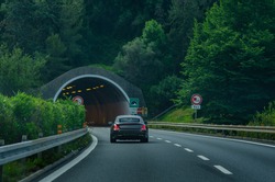 The luxury car entering the road tunnel on an Italian highway 