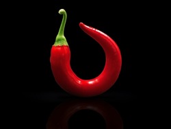 round curved red chili pepper isolated on black background