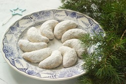 Vanilkipferl - vanilla crescents, traditional Christmas cookies in Germany, Austria, Czech Republic. Homemade cookies in Christmas or New Year's decor. Selective focus.