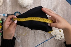 measuring with tape measure piece of fabric background materials for sewing, needlework and design in studio, work tools