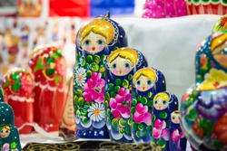 colored matrioskas at the russian shop on blur background