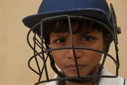 Portrait of boy wearing cricket Helmet