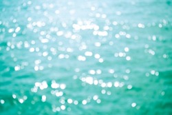 Blur bokeh on sea water with over light. light glow abstract background free space. nature landscape backdrop. tourism vacation travel summer in holidays. white texture wallpaper island flat lay.
