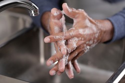 Washing hands with soap and water at the faucet, Hygiene concept