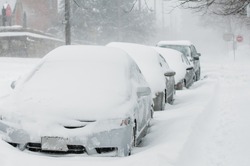 snow covered cars line up after storm,