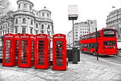Double-decker bus and Red telephone boxes with black and white background, London, UK.