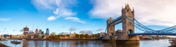 Panoramic London skyline with iconic symbol, the Tower Bridge and Her Majesty's Royal Palace and Fortress, known as the Tower of London as viewed from South Bank of the River Thames in the morning