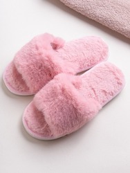 Pink women's home slippers and towel on light background. Comfortable shoes for home